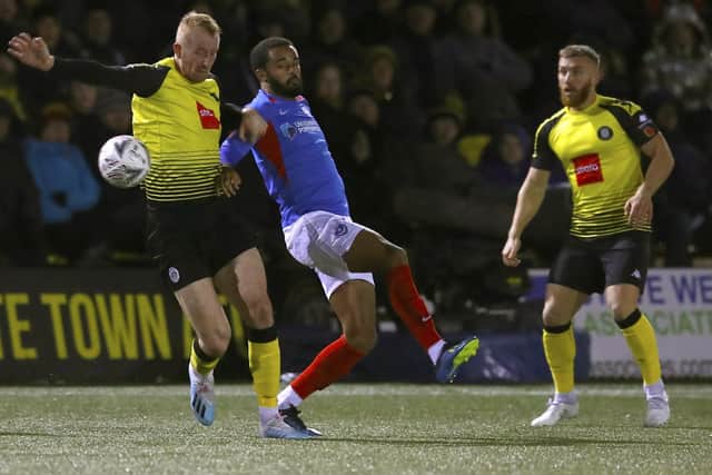 UP FOR THE CUP: Harrogate Town's Mark Beck (left) and Portsmouth's Anton Walkes battle for the ball during their FA Cup first round clash at the CNG Stadium in November last year. Picture: Martin Rickett/PA