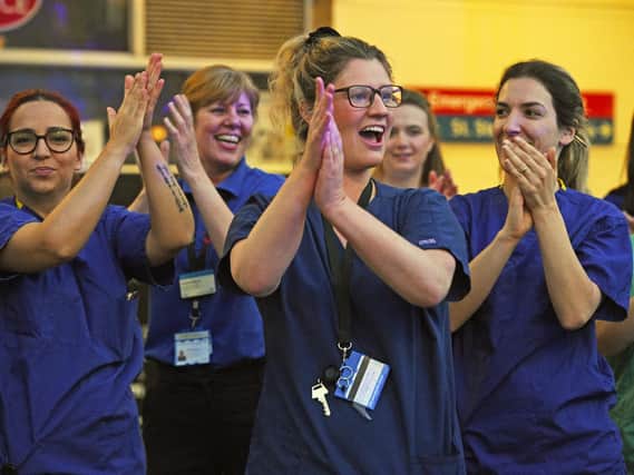 NHS staff respond during Thursday's nationwide Clap for Carers initiative to applaud NHS workers fighting the coronavirus pandemic