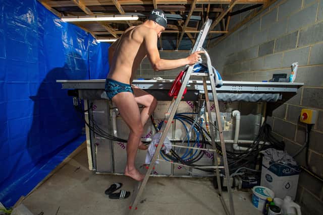 Double Olympic champion Alistair Brownlee climbs into his makeshift swimming pool.