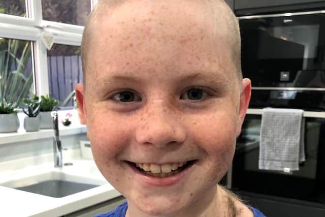 Jude Ashton, aged 10, having his head shaved to help the charity Leeds Cares.
