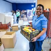 Lingile Maboyi, a nurse at St James Hospital, Leeds, receives the food package. Photo credit: Other