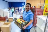 Lingile Maboyi, a nurse at St James Hospital, Leeds, receives the food package. Photo credit: Other