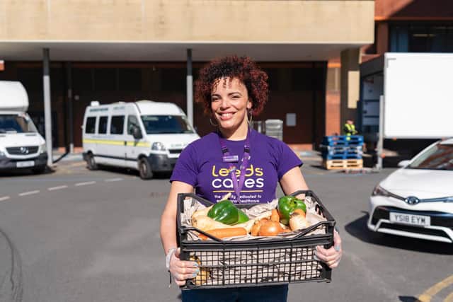 Pictured Helen Macdonald from Leeds Cares with the bags of free fresh fruit and vegetables. Photo credit: Other