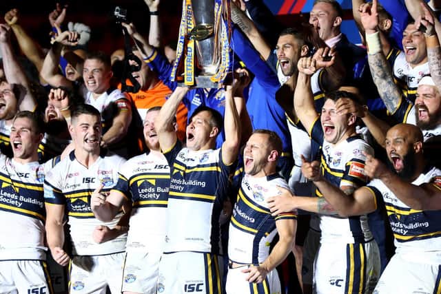 Danny McGuire and Rob Burrow lift the Super League trophy after Rhinos' 2017 Grand Final victory. Picture by Getty Images.