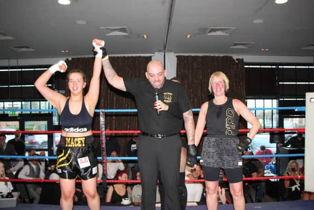 Macey Newberry and Patricia Furness, right, in the ring with the referee as the winner is declared. Picture by Julian Hudson