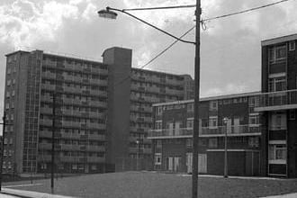 Different styles of housing in the Beckett Street area of Burmantofts. To the left is a high rise block of flats with smaller maisonette style apartments with built in garages seen to the right.