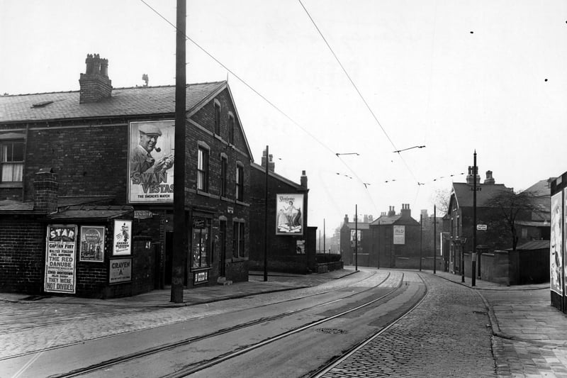 A view looking south west along Stoney Rock Lane past Fraser Street and Roland Webbs, Confectionery Shop.