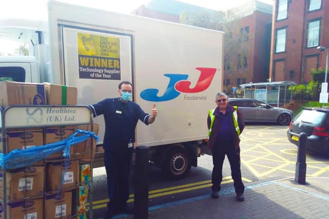 Senior Charge Nurse JasonSwarbrooke (left) at St James's Hospital accepting the 1,500 free mealsfrom JJ Foodservice.