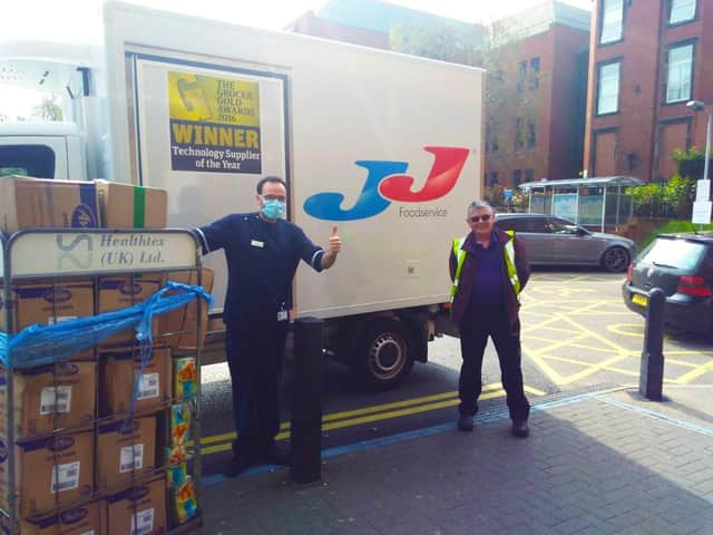 Senior Charge Nurse JasonSwarbrooke (left)  at St James's Hospital accepting the 1,500 free mealsfrom JJ Foodservice.