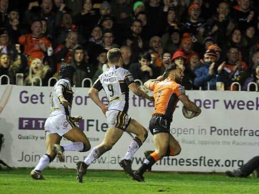 Luke Gale scores for Castleford Tigers during their 66-10 win over Leeds three years ago. Picture by Steve Riding.