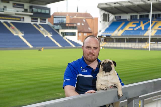 Leeds Rhinos' head groundsman Ryan Golding with groundspug and chief pigeon scarer Sherman. Picture by Tony Johnson.