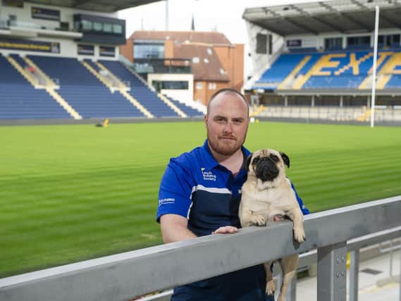 Leeds Rhinos' head groundsman Ryan Golding with groundspug and chief pigeon scarer Sherman. Picture by Tony Johnson.