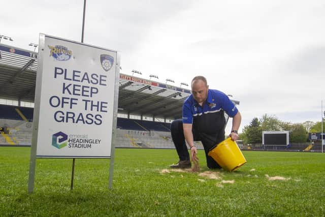 Ryan Golding repairs damage done by foxes to the Emerald Heaidngley pitch. Picture by Tony Johnson.