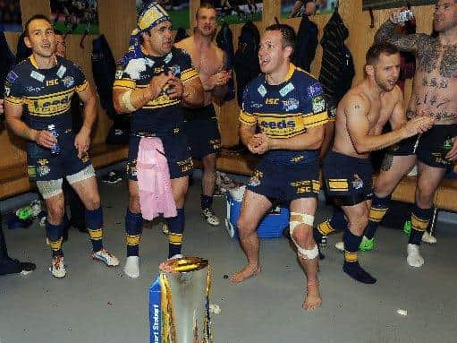 Danny McGuire leads Rhinos' victory song in the Old Trafford changing rooms. Picture by Steve Riding.
