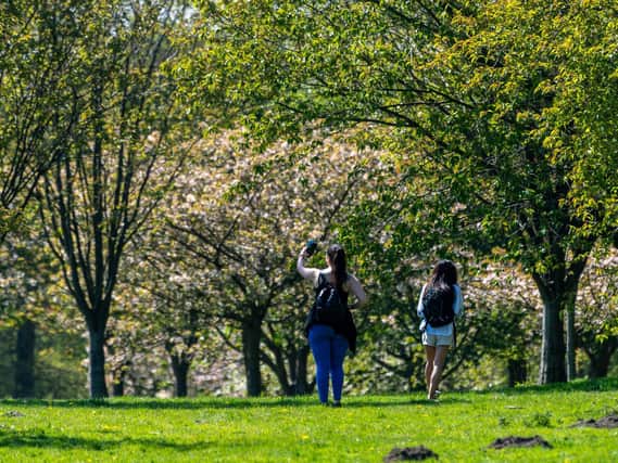 Two people enjoying a socially distant walk at Golden Acre Park, in Leeds, at the weekend.