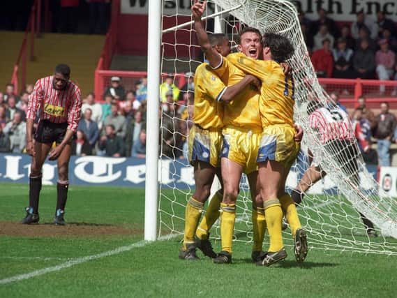 CHAMPIONS:  Leeds United v Sheffield United (title winning match). Jon Newsome, arm aloft, celabrating the winning goal with Chris Fairclough and Gary Speed (no.11). Brian Deane of Sheffield slumps in despair.