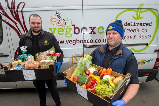 Danny Arnold and Richard Buck loading the vans ready for fresh fruit and veg deliveries.