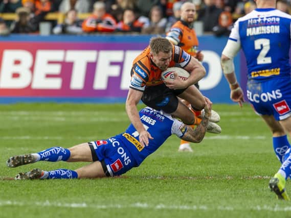 Michael Shenton is tackled by Theo Fages in Tigers' final game before Super League was suspended. Picture by Tony Johnson.