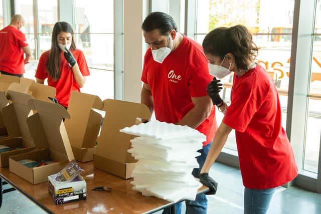 Ikram Butt and fellow volunteers prepare frontline care boxes.