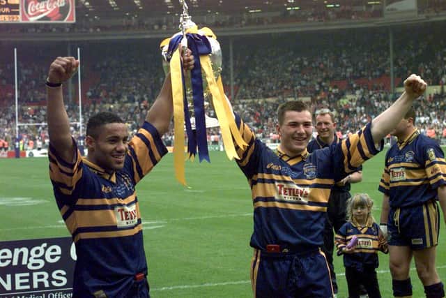 Leroy Rivett and Iestyn Harris show off the Challenge Cup after Rhinos' record-breaking win over London. Picture by Mike Cowling.