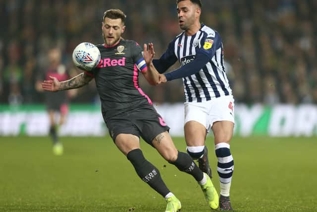 SEND THEM UP: Leeds United captain Liam Cooper holds off West Brom's Hal Robson-Kanu in the New Year's Day clash at The Hawthorns. Photo by Lewis Storey/Getty Images.