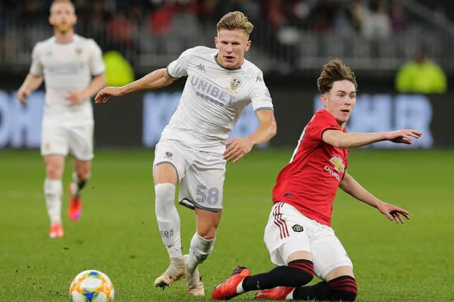 WAITING GAME: For Leeds United's 18-year-old Polish midfielder Mateusz Bogusz, left, pictured escaping Manchester United's James Garner during last June's pre-season friendly in Perth. Photo by Will Russell/Getty Images.