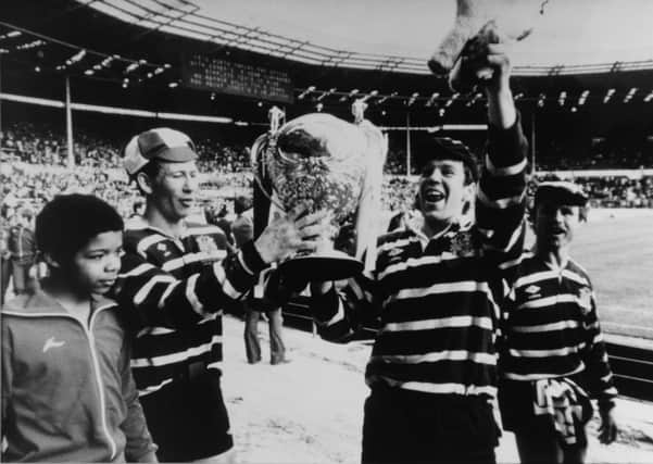 Featherstone Rovers' Peter Smith, Steve Quinn and Ken Kellett show the fans the Challenge Cup.