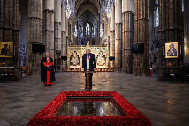 Boris Johnson lights a candle at the Tomb of the Unknown Warrior in Westminster Abbey.