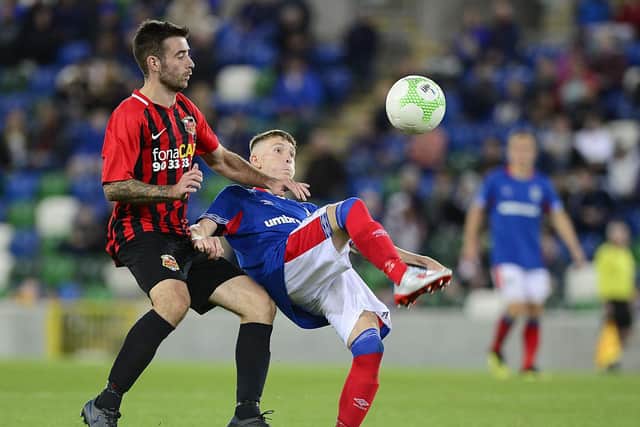 YOUNG GUN: Linfield's Charlie Allen and East Belfast's Nathan McVeigh pictured in action at Windsor Park in Belfast. Pic: Arthur Allison / Pacemaker Press