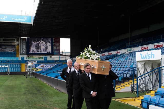 Norman Hunter's coffin being carried through Elland Road.