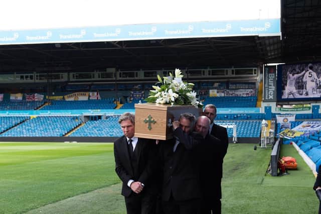 FITTING: Leeds United legend Norman Hunter's coffin is carried out at Elland Road in front of the South Stand, behind, that now carries Hunter's name. Picture by Leeds United.