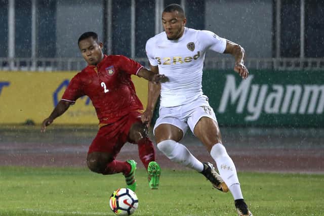 FORGOTTEN MAN: Jay-Roy Grot, right, vies for the ball with Htike Aung during Leeds United's pre-season friendly against Myanmar in Mandalay in May 2018. Photo by MYO KYAW SOE/AFP via Getty Images.
