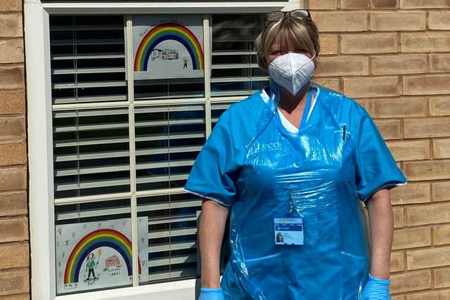 Debra Elbourne in the PPE that her teams wear during home visits.
