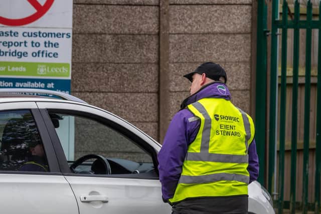 Security staff manage the flow of cars into Seacroft recycling centre. Photo: James Hardisty