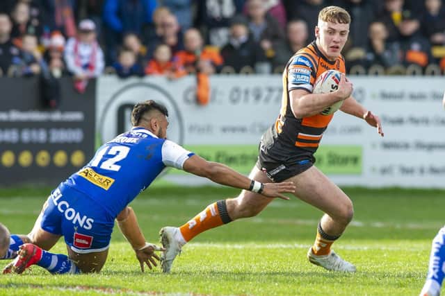 Tigers' Jake Trueman gets away from Dominique Peyroux of St Helens. Picture by Tony Johnson.