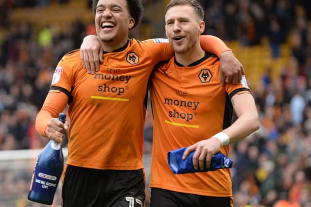 BACK TOGETHER: Helder Costa and Barry Douglas, now reunited at Leeds, celebrate promotion to the Premier League with Wolves following victory against Birmingham City at Molineux in April 2018. Photo by Nathan Stirk/Getty Images.