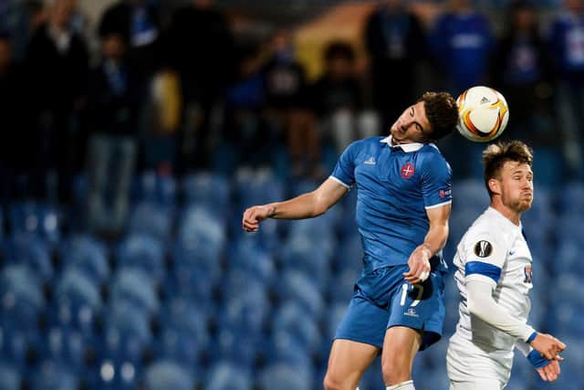 POLISH ADVENTURE: Barry Douglas, right, in action for Lech Poznan. Photo by PATRICIA DE MELO MOREIRA/AFP via Getty Images.