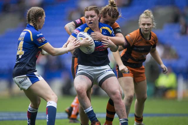 LEADING THE LINE: Danielle Anderson of Leeds is tackled by Rhiannon Marshall of Castleford. Picture by Isabel Pearce/SWpix.com