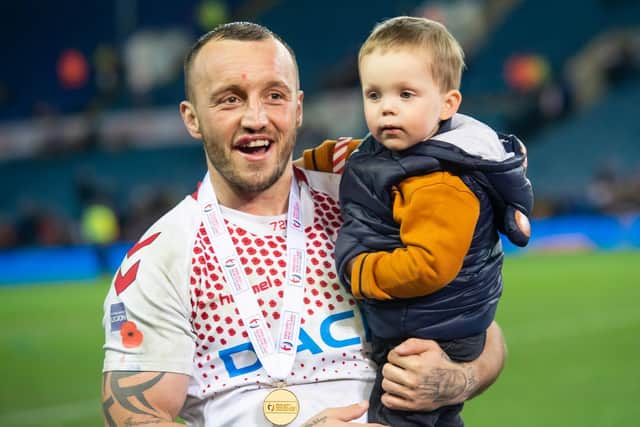 England's Josh Hodgson with the Baskerville Trophy and his son after helping earn a test series win over New Zealand at Elland Road in 2018. (Allan McKenzie/SWpix.com)