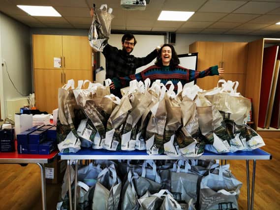 Lockdown challenge volunteers Emily Duff and Luke Gaillet with some of the 700 free packs deliveved to families in south Leeds.