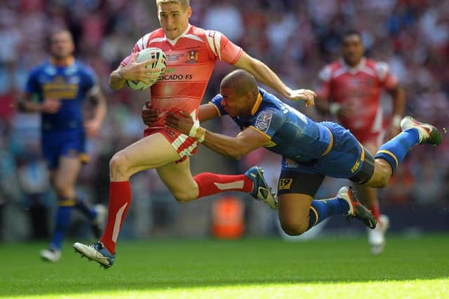 Sam Tomkins is tackled by Kallum Watkins at Wembley in 2011. Picture by Anna Gowthorpe/PA Wire