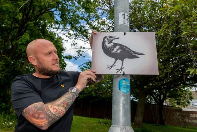 Neil Morgan, with his painting of a crow in The LS11 Art Gallery. Picture: James Hardisty
