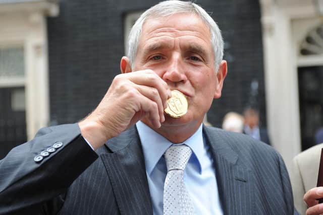NATIONAL TREASURE: Norman Hunter kisses his medal for representing his country in the 1966 World Cup triumph, presented by Prime Minister Gordon Brown in 2009. Photo by Ian Nicholson/WPA Pool/Getty Images.