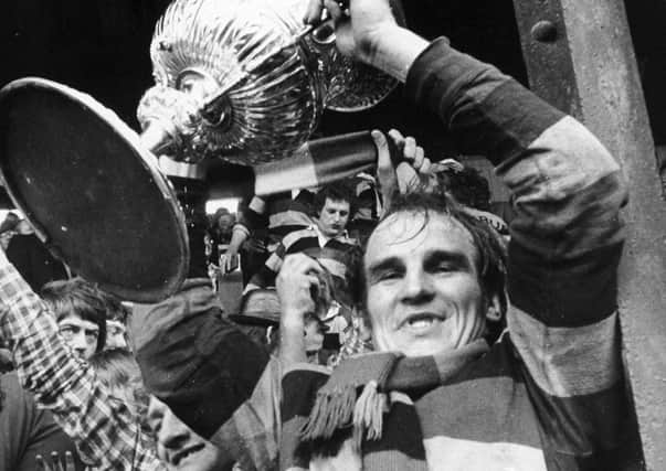 Mick Stephenson holds the Championship trophy aloft in 1973 after Dewsbury's victory over Leeds. Picture: YPN.