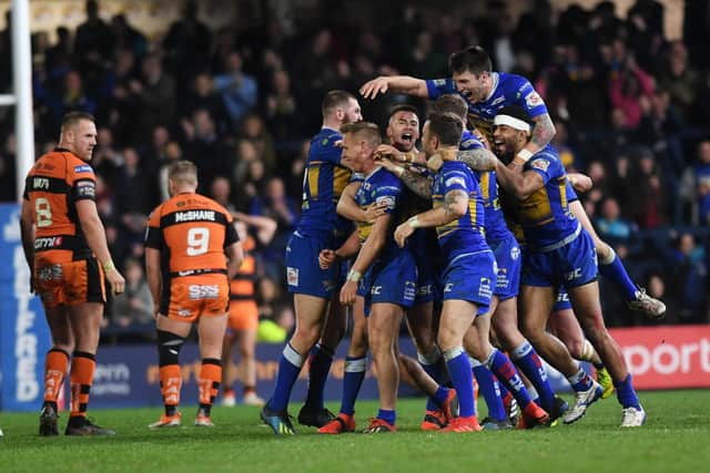 Brad Dwyer is mobbed by his team-mates after his golden point drop goal against Castleford Tigers last season.
Picture: Jonathan Gawthorpe.