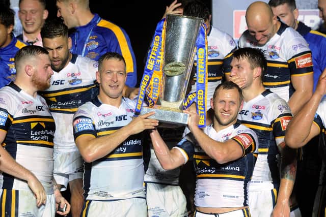 Danny McGuire and Rob Burrow lift the Super League trophy in 2017. Picture: Bruce Rollinson.