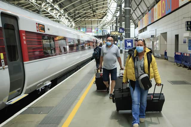 People wear a face masks at Leeds station, as train services increase as part of the easing of coronavirus lockdown restrictions. Photo: Danny Lawson, PA