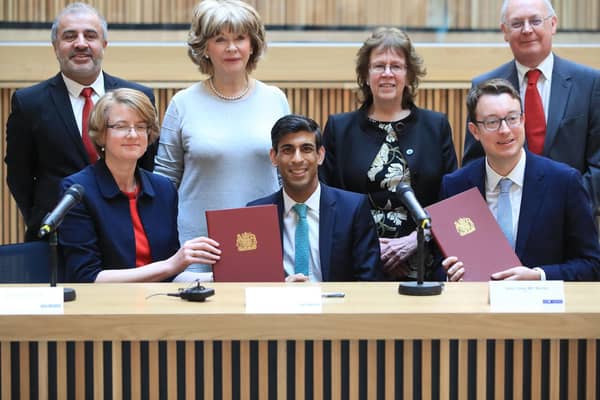 Local council leaders sign the proposed agreement, alongside Chancellor Rishi Sunak in March.