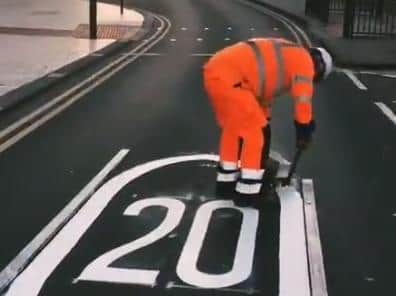 A council worker painting on the new 20 miles per hour zones in Leeds city centre. Photo: Connecting Leeds
