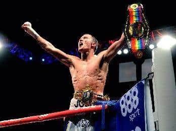 ARMS RAISED: Josh Warrington with his Commonwealth and British titles. Picture: Picture: Jonathan Gawthorpe.